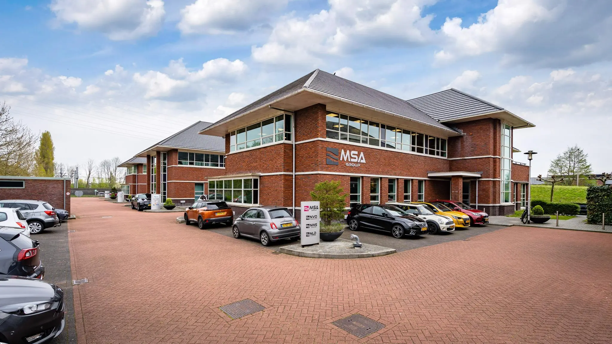 Modern kantoorpand van MSA Group aan de 1e Barendrechtseweg met geparkeerde auto's op de voorgrond.
